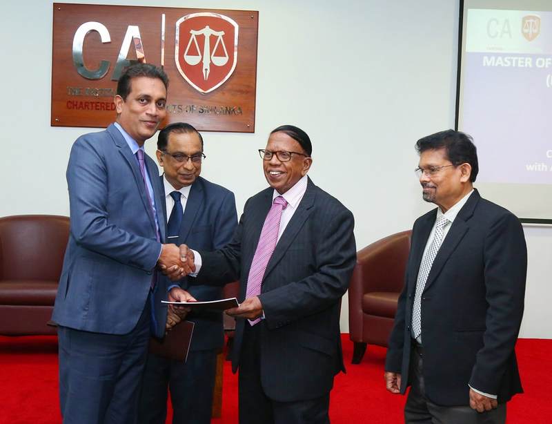 Mr. Kanagasabapathy presenting the prospectus to Mr. Heshana Kuruppu in the presence of Prof. Chandana Udawatte and Mr. Prasanna Liyanage, Acting Chief Executive Officer of CA Sri Lanka