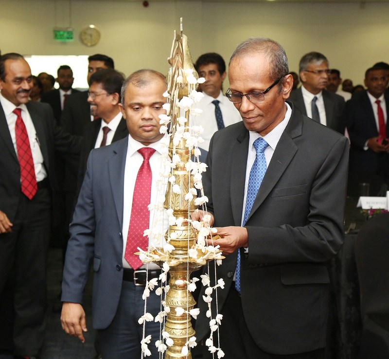 Chief Guest Mr. D. R. S. Hapuarachchi, Commissioner General of Inland Revenue lighting the oil lamp in the presence of Mr. Sanjaya Bandara, President of CA Sri Lanka.