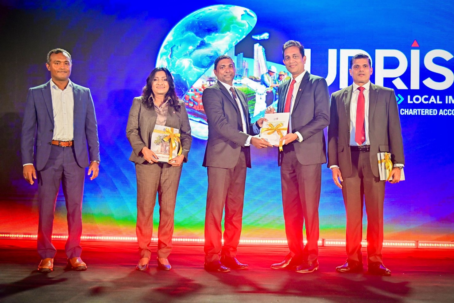 Mr. Heshana Kuruppu being presented with the guide.